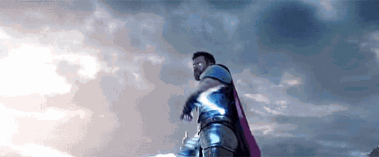 a man in a cape is standing in the sky
