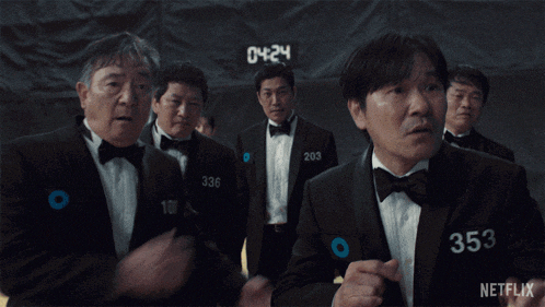 a group of men in tuxedos and bow ties are standing in front of a netflix sign
