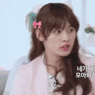 a girl with long hair and a pink bow in her hair .