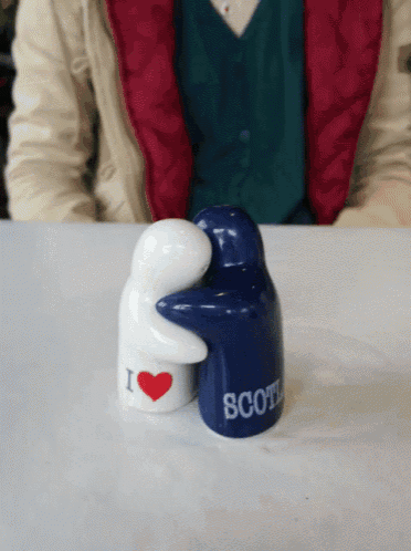 a blue salt and pepper shaker that says scotland on it