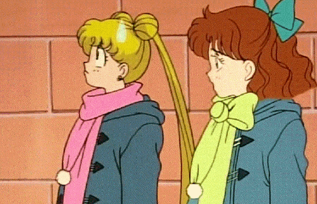 a couple of girls standing next to each other with one wearing a pink scarf