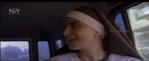 a nun is sitting in a car with a sgv digital logo on the bottom