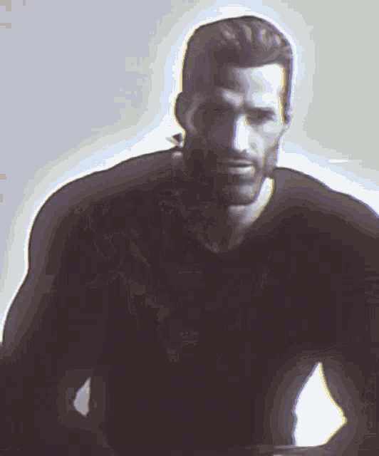a man with a beard is wearing a black shirt and looking at the camera