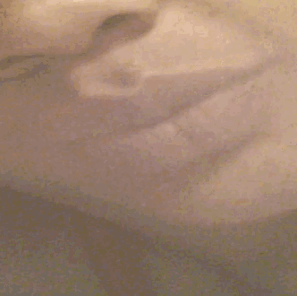 a close up of a person 's face in a bathtub with steam coming out of it