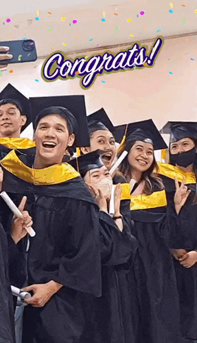 a group of graduates are posing for a picture with the words congrats on the top
