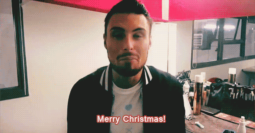 a man with a beard says merry christmas in a video
