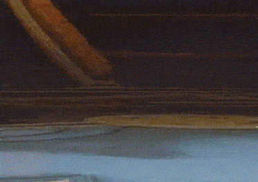 a car is driving down a road with smoke coming out of it 's windshield