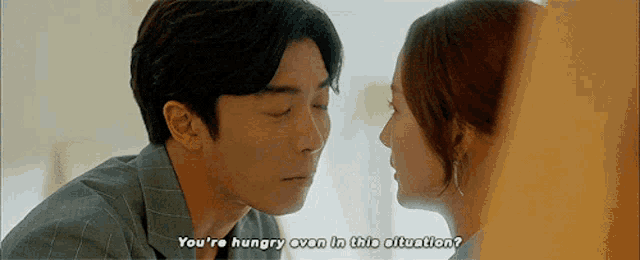 a man and a woman are looking at each other and the man says you 're hungry even in this situation .