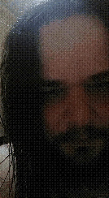 a close up of a man 's face with a beard
