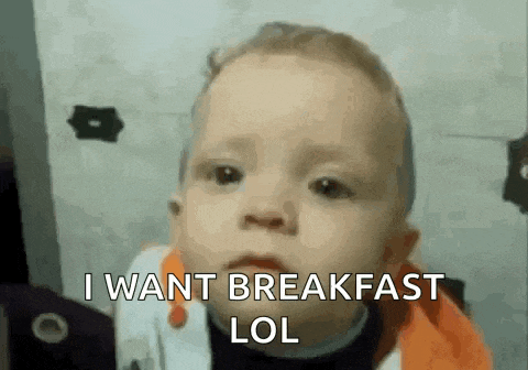 a baby is making a funny face and saying `` i want breakfast lol '' .