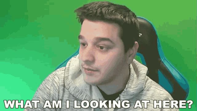a man sitting in a chair with the words " what am i looking at here " above him