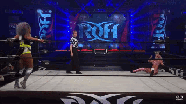a female wrestler in a ring with a roh logo in the background
