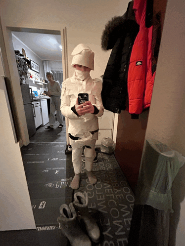 a person in a mummy costume takes a picture of themselves