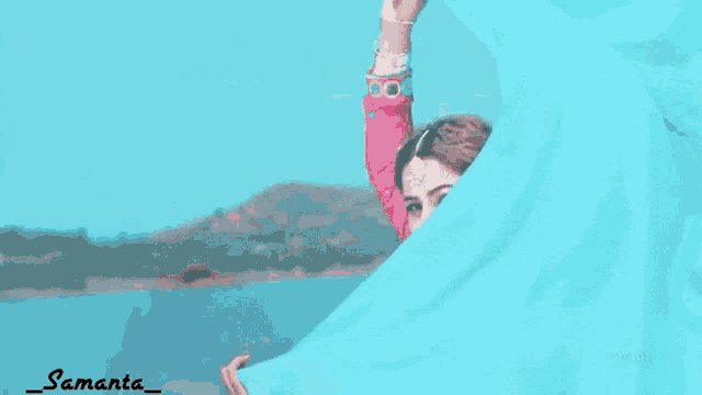 a woman in a pink dress is holding a blue cloth and the name samanta is on the bottom right