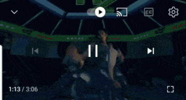 a group of people are dancing in a room with a neon sign that says nz .
