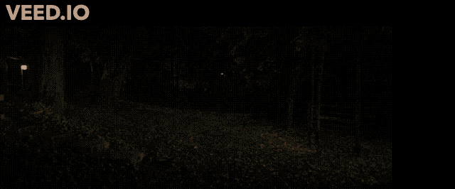 a log cabin is lit up at night with the website veed.io visible