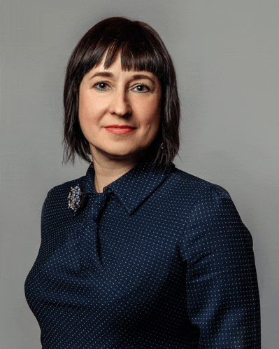 a woman wearing a blue shirt with white polka dots