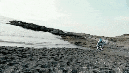 a person is riding a dirt bike on a sandy beach