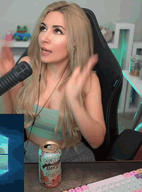 a woman sitting in a chair with a can of arizona hard