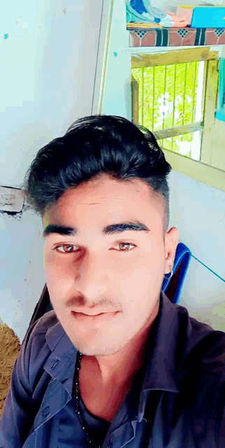 a young man taking a selfie with a mirror in the background