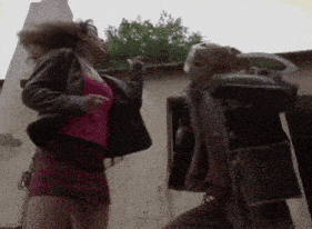 a woman in a red skirt is fighting a man in a brown jacket