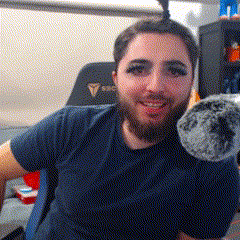 a man with a beard is holding a stuffed animal .