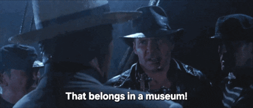 a man in a cowboy hat is talking to another man who says that belongs in a museum