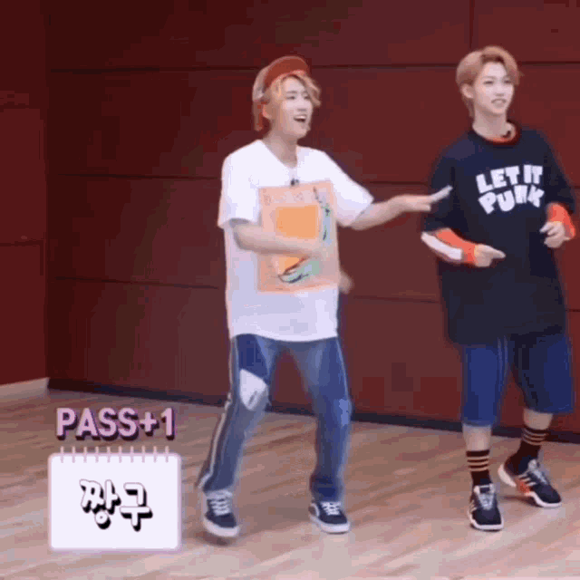 two young men are dancing together in a room .