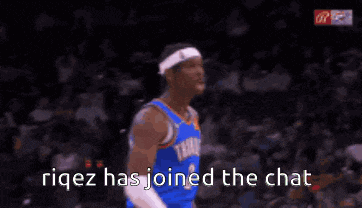 a basketball player is screaming during a game while wearing a headband and a number 2 jersey .