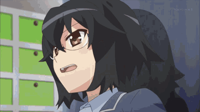 a girl with glasses is sitting in front of a tokyo mx logo