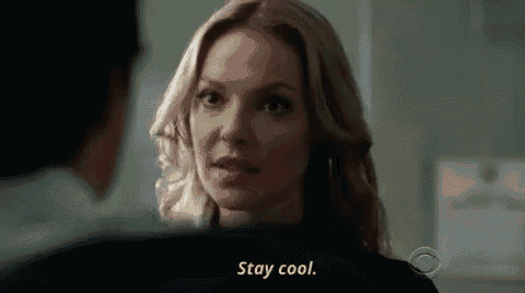 a close up of a woman talking to a man and saying `` stay cool '' .