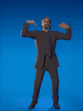 a man in a suit and tie is pointing at something