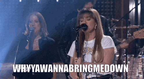 a woman singing into a microphone with the words " why ya wanna bring me down " next to her