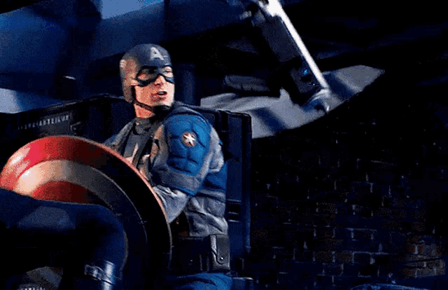 captain america is holding a red white and blue shield