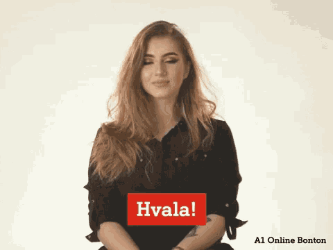 a woman in a black shirt with a red sign that says hvala