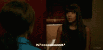 a woman in a blue shirt is talking to another woman in a black top .