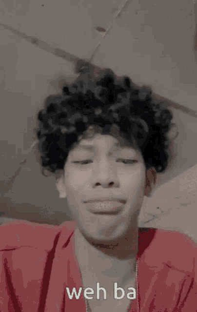 a young man with curly hair is making a funny face with the words weh ba written below him