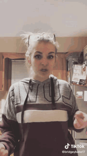 a woman wearing a sweatshirt that says ' fun ' on it