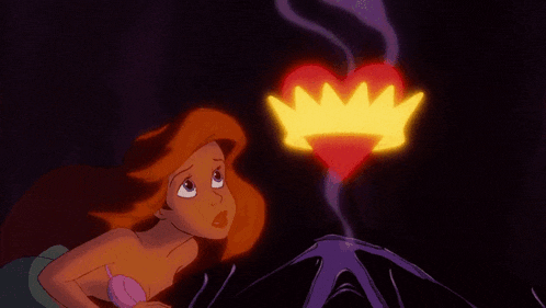 a little mermaid looks at a heart with a crown coming out of it