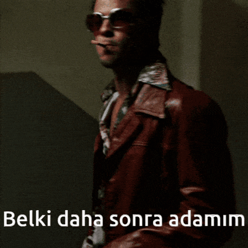 a man smoking a cigarette with the words belki daha sonra adamim written below him