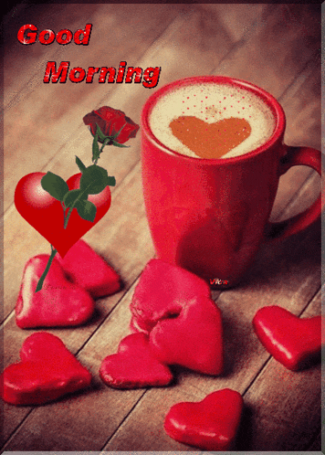 a cup of coffee with a heart in the foam and a rose on a table