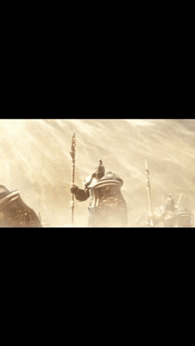 a man in armor holding a spear and shield
