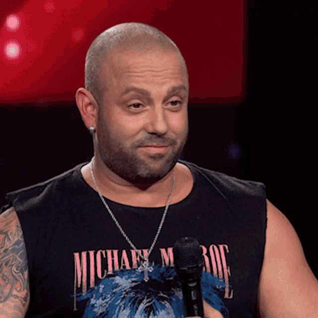 a man wearing a michael jackson shirt holds a microphone in his hand
