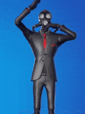 a man in a suit and gas mask is holding a cell phone in his hands .