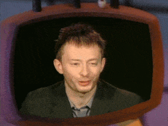 a man in a suit is being shown on a tv screen