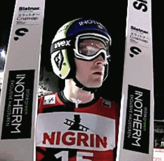 a man wearing a helmet and goggles is wearing a shirt that says nigrin on it