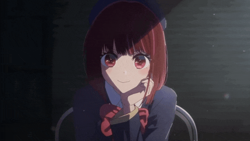 a girl with red hair is sitting in a dark room with her hand on her chin