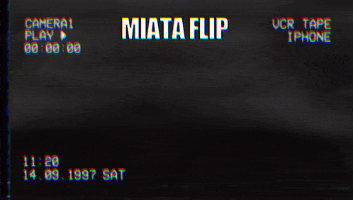 a video of a phone being played on a camera with the words " miata flip " at the top