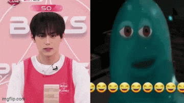 a man in a pink tank top next to a cartoon character with smiley faces .