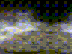 a blurred image of a person 's feet walking on a tiled floor